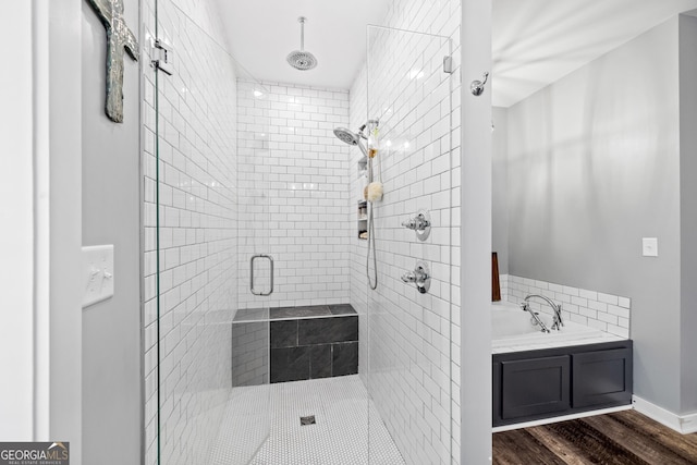 2109 Brewers Mill Rd, Elberton, GA 30635 - bathroom featuring a stall shower, a garden tub, and wood finished floors