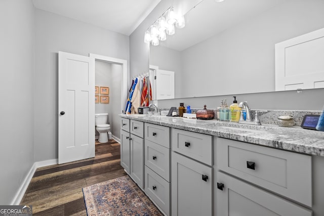 2109 Brewers Mill Rd, Elberton, GA 30635 - bathroom with toilet, double vanity, wood finished floors, and baseboards