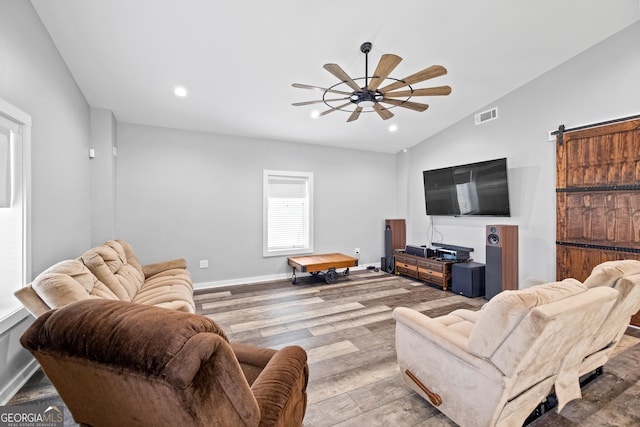 2109 Brewers Mill Rd, Elberton, GA 30635 - living room with wood finished floors, ceiling fan, vaulted ceiling, baseboards, and a barn door
