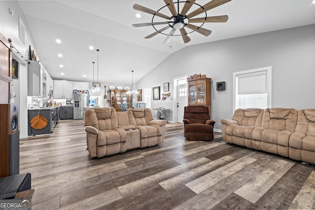 2109 Brewers Mill Rd, Elberton, GA 30635 - living room with vaulted ceiling, a ceiling fan, wood finished floors, a chandelier, and a barn door