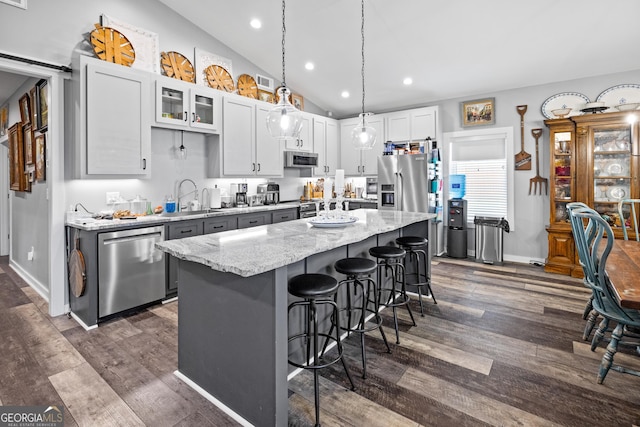 2109 Brewers Mill Rd, Elberton, GA 30635 - kitchen with appliances with stainless steel finishes, a sink, a breakfast bar, a center island, and dark wood finished floors