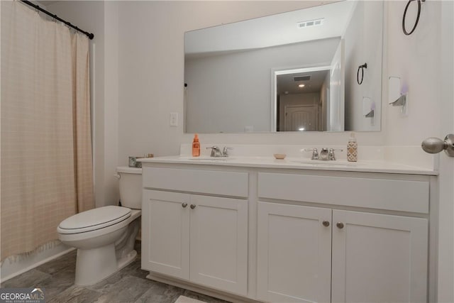 full bathroom with toilet, double vanity, and a shower with shower curtain