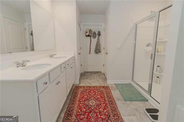 full bathroom with a shower stall and double vanity