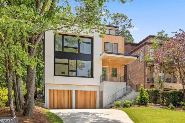 1287 Star Dr NE, Brookhaven, GA 30319 - modern home with an attached garage, driveway, stairs, and stucco siding