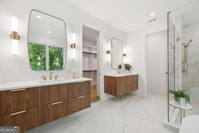 1287 Star Dr NE, Brookhaven, GA 30319 - bathroom featuring a marble finish shower, two vanities, a spacious closet, marble finish flooring, and recessed lighting