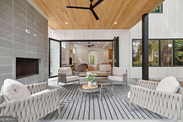 1287 Star Dr NE, Brookhaven, GA 30319 - living room with ceiling fan, wooden ceiling, a tiled fireplace, and recessed lighting