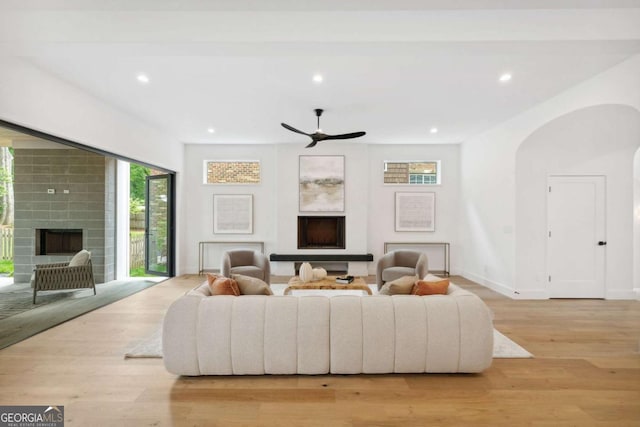 1287 Star Dr NE, Brookhaven, GA 30319 - living room with a fireplace, light wood finished floors, recessed lighting, a ceiling fan, and arched walkways