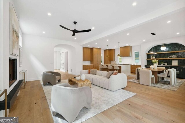 1287 Star Dr NE, Brookhaven, GA 30319 - living room with arched walkways, recessed lighting, light wood-type flooring, a ceiling fan, and baseboards