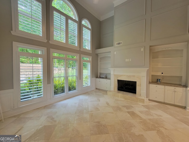 45 Mountain Crest Dr, Oxford, GA 30054 - unfurnished living room with a towering ceiling, built in shelves, and a high end fireplace