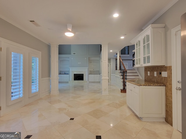 45 Mountain Crest Dr, Oxford, GA 30054 - kitchen featuring a ceiling fan, glass insert cabinets, white cabinetry, dark stone countertops, and a premium fireplace