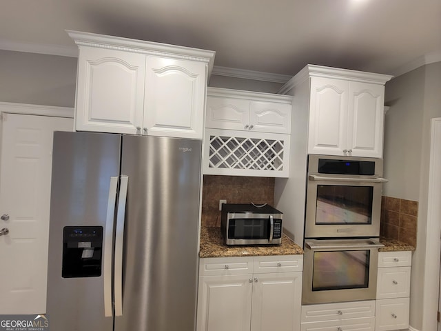 45 Mountain Crest Dr, Oxford, GA 30054 - kitchen with appliances with stainless steel finishes, dark stone countertops, white cabinets, ornamental molding, and tasteful backsplash