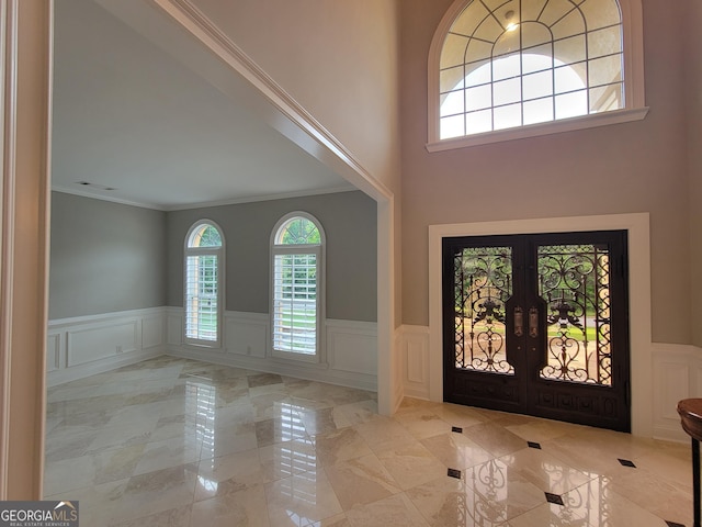 45 Mountain Crest Dr, Oxford, GA 30054 - entrance foyer with a decorative wall, ornamental molding, french doors, and wainscoting