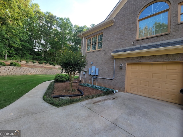 45 Mountain Crest Dr, Oxford, GA 30054 - view of property exterior featuring brick siding, a garage, a yard, and concrete driveway
