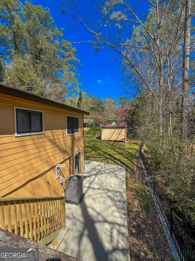 3082 Dove Way, Decatur, GA 30033 - view of side of property with a patio, central AC unit, an outbuilding, and a storage unit