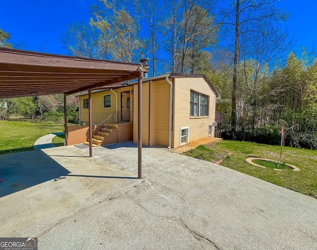 3082 Dove Way, Decatur, GA 30033 - back of house with a lawn, brick siding, a carport, and a patio