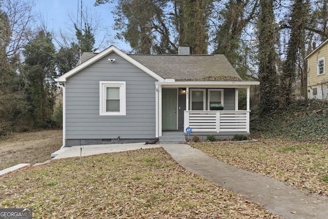 251 Aurora Ave NW, Atlanta, GA 30314 - bungalow with covered porch, a chimney, and roof with shingles