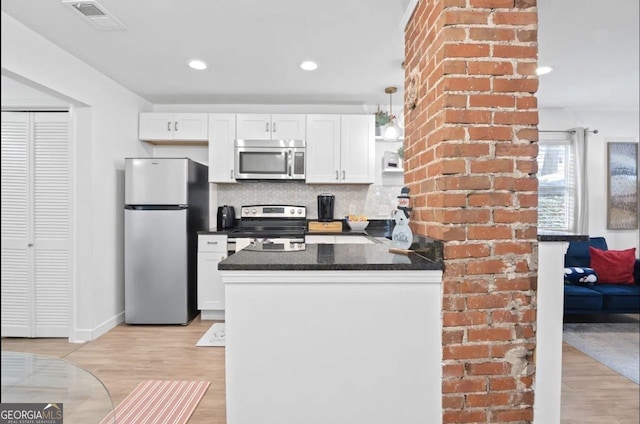 251 Aurora Ave NW, Atlanta, GA 30314 - kitchen with appliances with stainless steel finishes, white cabinets, light wood finished floors, decorative backsplash, and recessed lighting