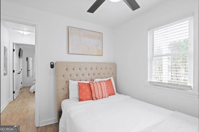 251 Aurora Ave NW, Atlanta, GA 30314 - bedroom with attic access, wood finished floors, a ceiling fan, and baseboards