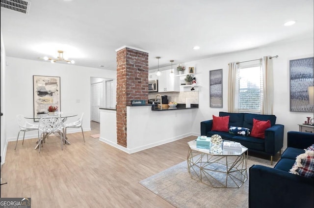 251 Aurora Ave NW, Atlanta, GA 30314 - living area with light wood-style floors, recessed lighting, baseboards, and a chandelier