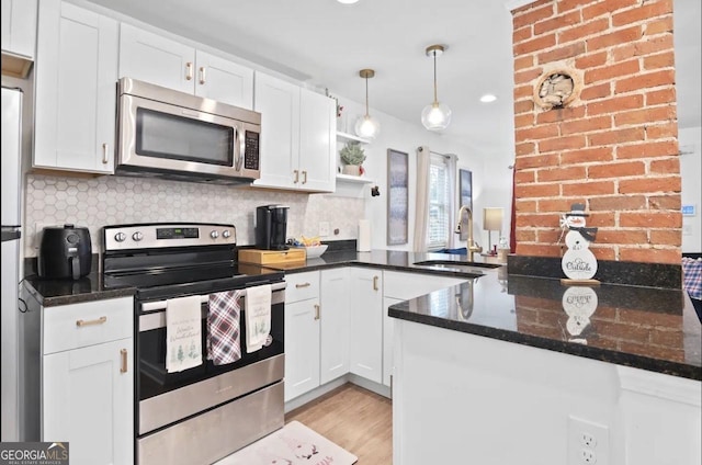 251 Aurora Ave NW, Atlanta, GA 30314 - kitchen featuring appliances with stainless steel finishes, a sink, white cabinetry, and backsplash