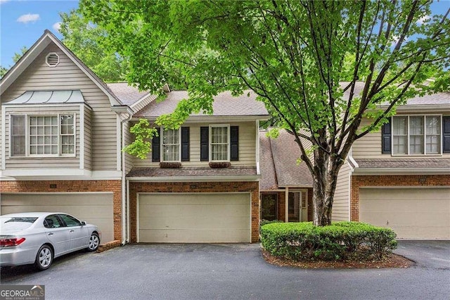 2908 Woodruff Dr SE, Smyrna, GA 30080 - view of property with an attached garage, asphalt driveway, and brick siding
