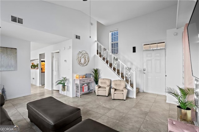 2540 Park Ave, Austell, GA 30106 - tiled living area featuring a high ceiling and stairway