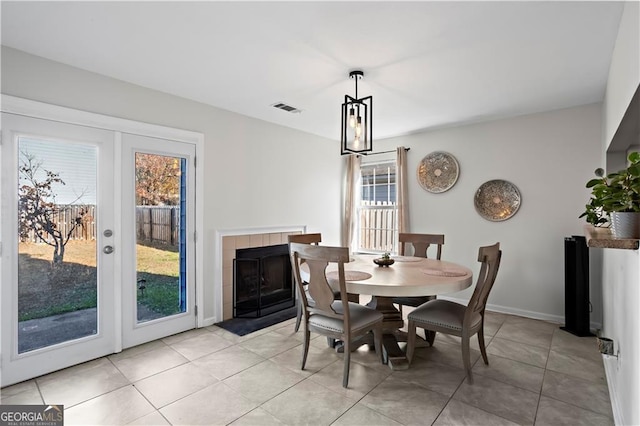2540 Park Ave, Austell, GA 30106 - dining space with plenty of natural light, light tile patterned flooring, a fireplace, and baseboards