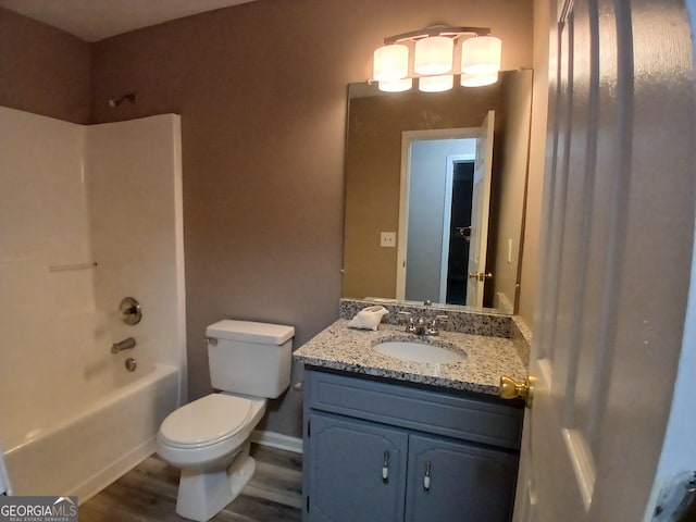 5517 Rock Shoals Way, Atlanta, GA 30349 - full bath with toilet, vanity, bathtub / shower combination, and wood finished floors