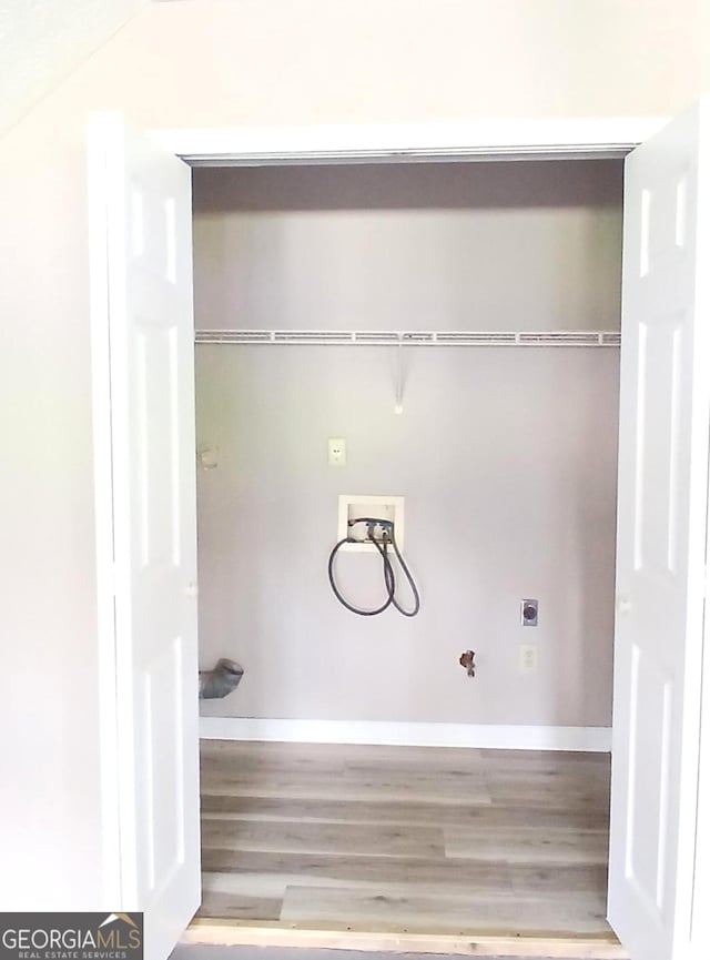5517 Rock Shoals Way, Atlanta, GA 30349 - laundry area featuring electric dryer hookup, hookup for a washing machine, and wood finished floors
