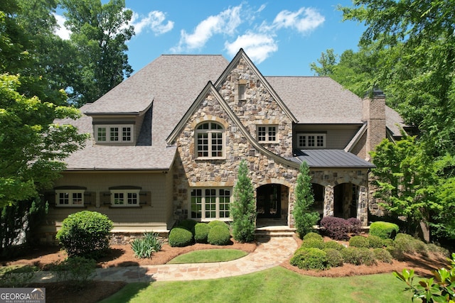 1023 Little Darby Ln, Suwanee, GA 30024 - view of front of property featuring stone siding, a shingled roof, a chimney, a standing seam roof, and a front yard
