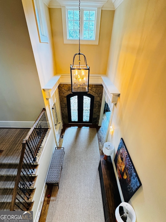 1023 Little Darby Ln, Suwanee, GA 30024 - foyer featuring a chandelier, ornamental molding, baseboards, and wood finished floors