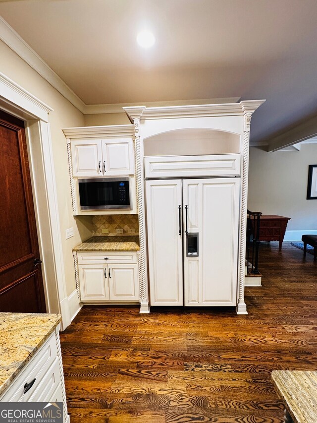 1023 Little Darby Ln, Suwanee, GA 30024 - kitchen featuring built in appliances, dark wood-style floors, ornamental molding, tasteful backsplash, and light stone countertops