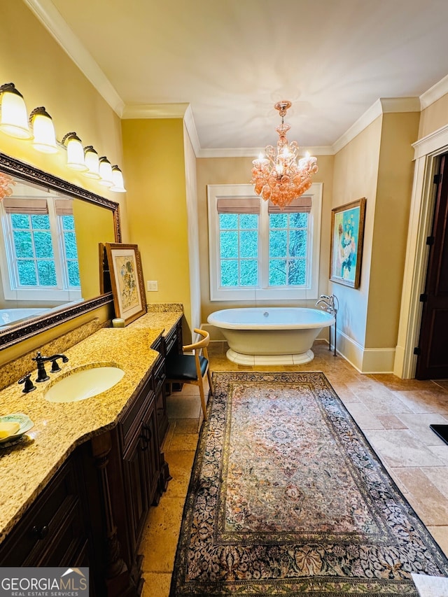 1023 Little Darby Ln, Suwanee, GA 30024 - bathroom featuring stone tile floors, baseboards, a freestanding bath, vanity, and a chandelier