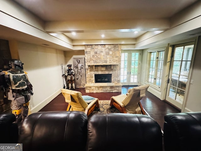 1023 Little Darby Ln, Suwanee, GA 30024 - living room with a tray ceiling, baseboards, wood finished floors, and a stone fireplace