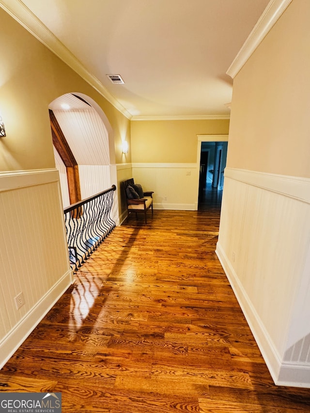 1023 Little Darby Ln, Suwanee, GA 30024 - corridor featuring wainscoting, arched walkways, ornamental molding, and wood finished floors