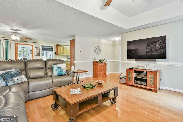 55 Hubbard Ct, Newnan, GA 30263 - living area with ceiling fan, light wood-style floors, and a textured ceiling