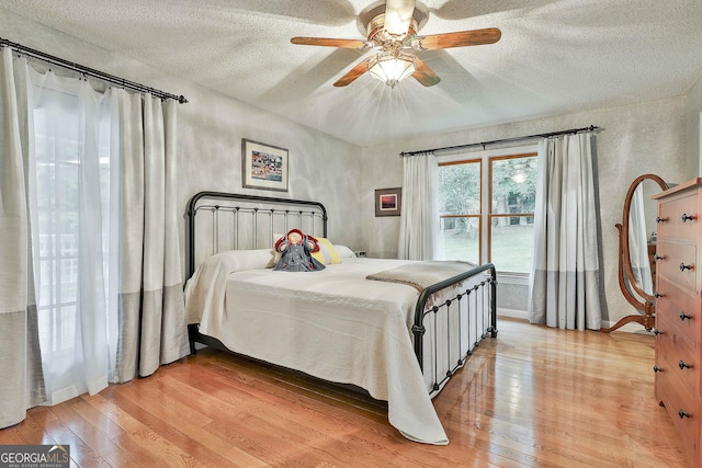 55 Hubbard Ct, Newnan, GA 30263 - bedroom with a textured ceiling, light wood-type flooring, and ceiling fan