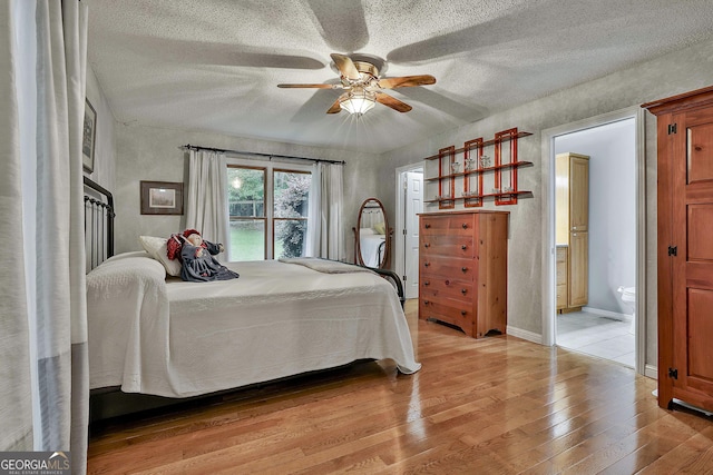 55 Hubbard Ct, Newnan, GA 30263 - bedroom with light wood-style flooring, a textured ceiling, a ceiling fan, and ensuite bathroom