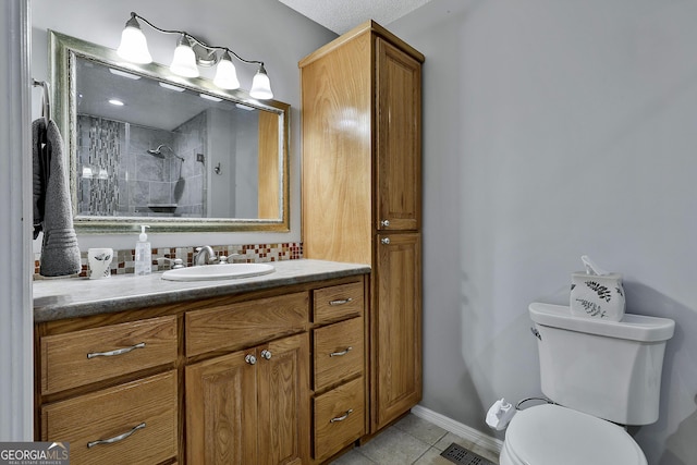55 Hubbard Ct, Newnan, GA 30263 - full bathroom with vanity, tile patterned floors, a tile shower, toilet, and baseboards