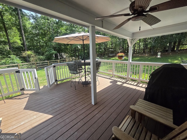 55 Hubbard Ct, Newnan, GA 30263 - wooden terrace featuring a ceiling fan, outdoor dining area, and view of wooded area