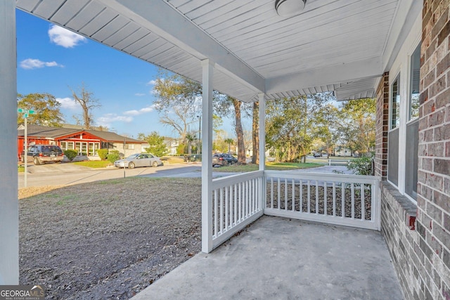 view of patio featuring covered porch and a residential view