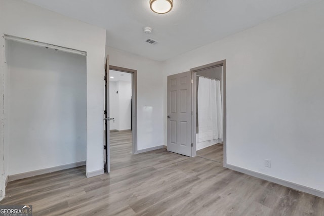 1601 Coventry St, Savannah, GA 31415 - unfurnished bedroom with light wood-style flooring, baseboards, and ensuite bath