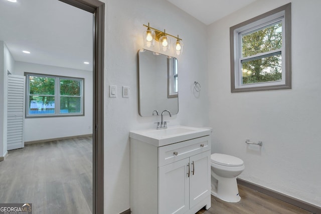 1601 Coventry St, Savannah, GA 31415 - bathroom featuring wood finished floors, toilet, vanity, and baseboards