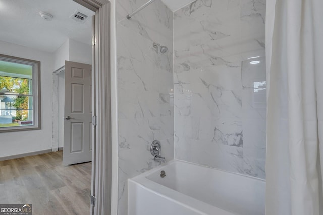 1601 Coventry St, Savannah, GA 31415 - full bath featuring shower / bath combo with shower curtain, wood finished floors, and baseboards