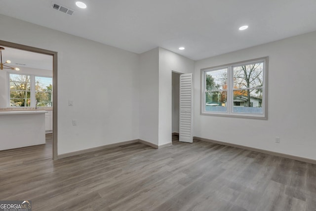 1601 Coventry St, Savannah, GA 31415 - unfurnished room with wood finished floors, baseboards, recessed lighting, and a chandelier