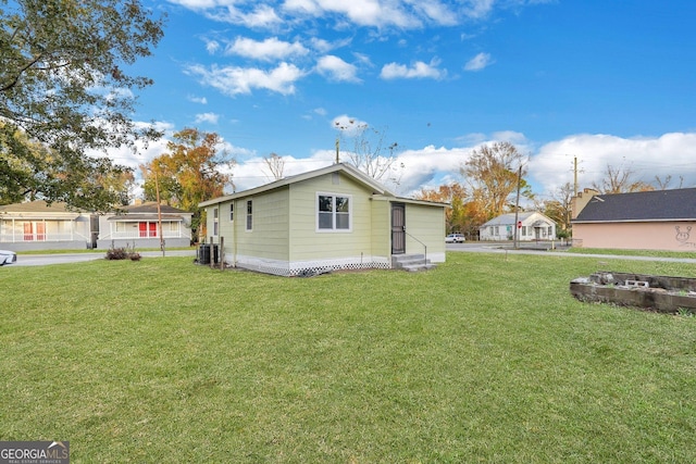 1601 Coventry St, Savannah, GA 31415 - view of home's exterior featuring central AC unit and a lawn