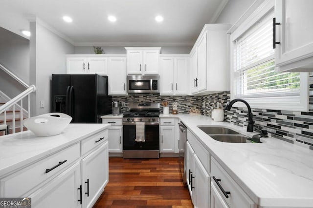 1630 Marsanne Ter NW Unit 27, Kennesaw, GA 30152 - kitchen featuring stainless steel appliances, a sink, white cabinetry, decorative backsplash, and crown molding