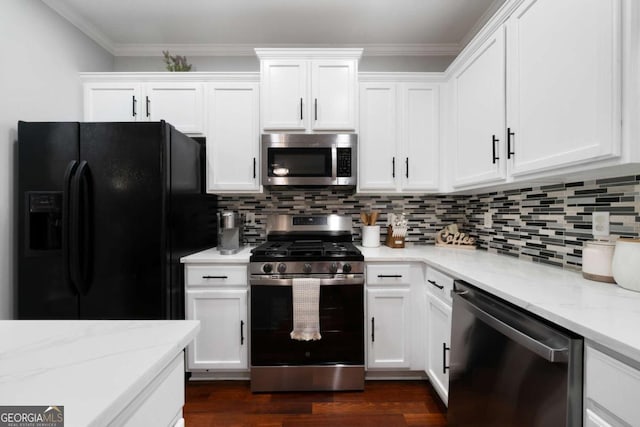 1630 Marsanne Ter NW Unit 27, Kennesaw, GA 30152 - kitchen with appliances with stainless steel finishes, white cabinets, light stone countertops, tasteful backsplash, and dark wood finished floors