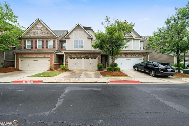 1630 Marsanne Ter NW Unit 27, Kennesaw, GA 30152 - view of front facade with an attached garage, driveway, stucco siding, and brick siding