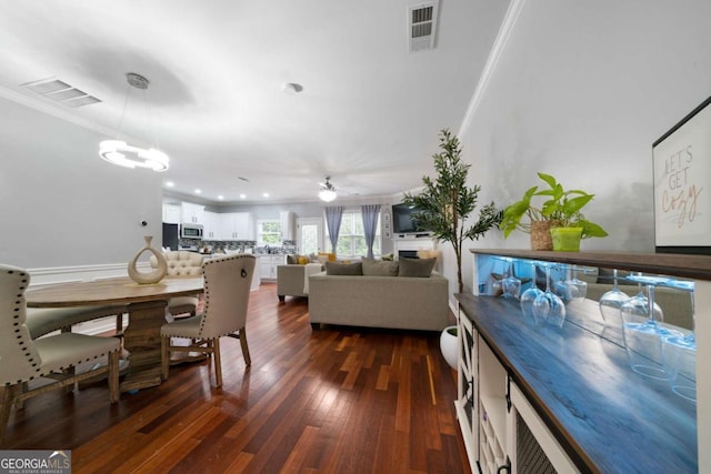 1630 Marsanne Ter NW Unit 27, Kennesaw, GA 30152 - dining room with ornamental molding, dark wood-type flooring, a chandelier, and a ceiling fan
